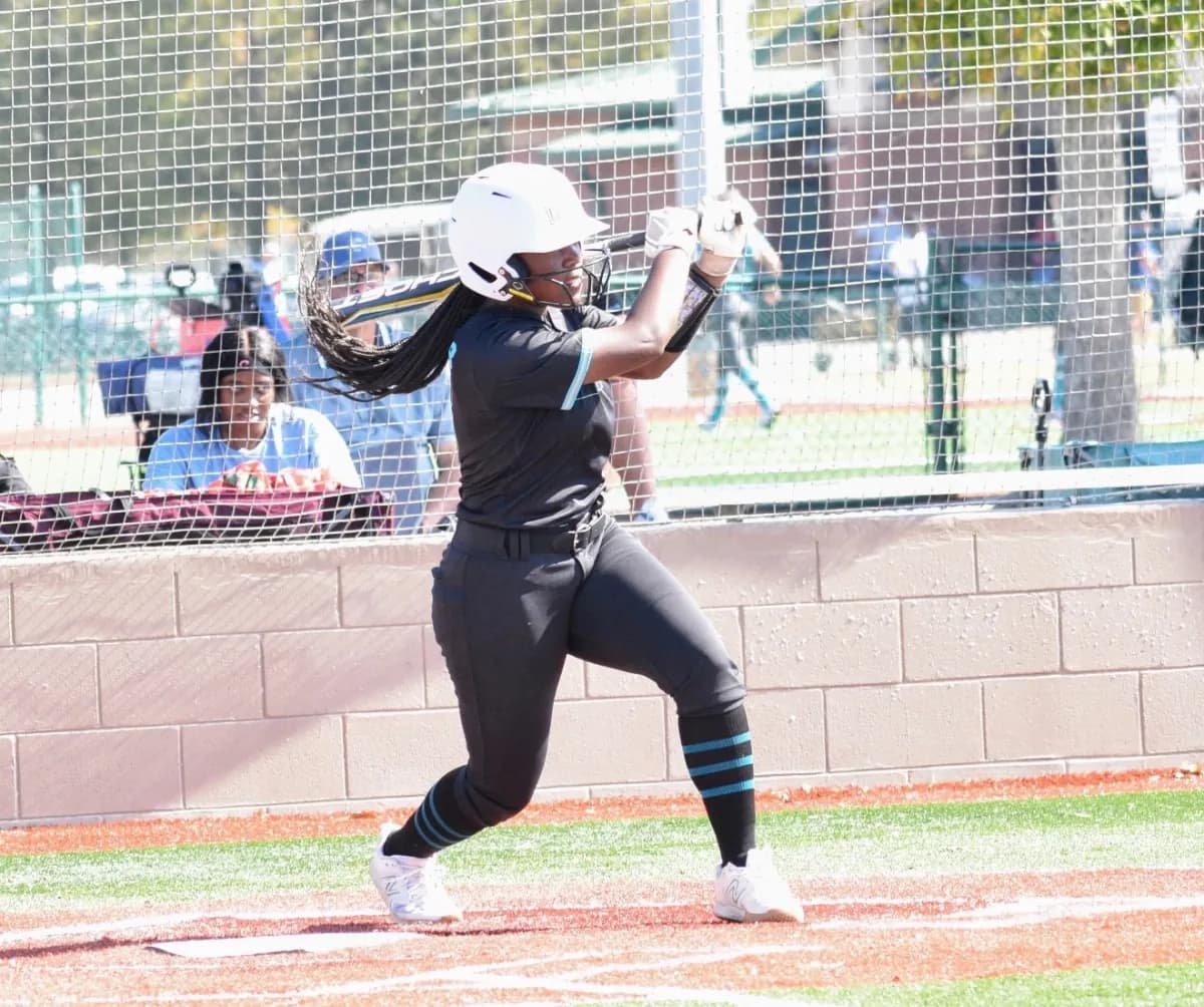 Kennedi Fair, Class of 2028 softball catcher, loaded in her batting stance in the box