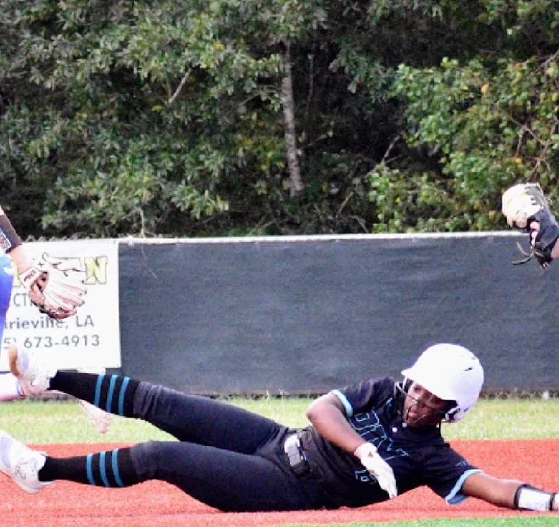 Kennedi Fair sliding into the base under the tag