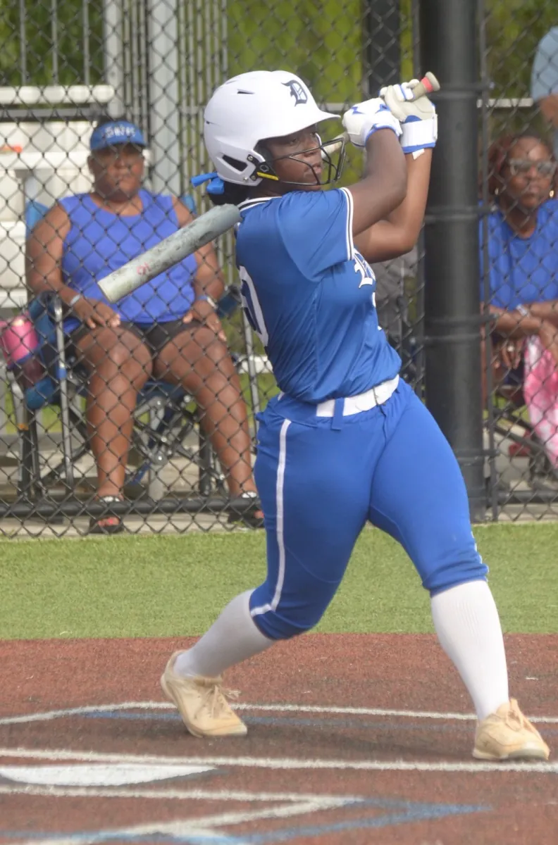Kennedi Fair (#10) swinging the bat at the plate in her Louisiana Lady Dukes uniform