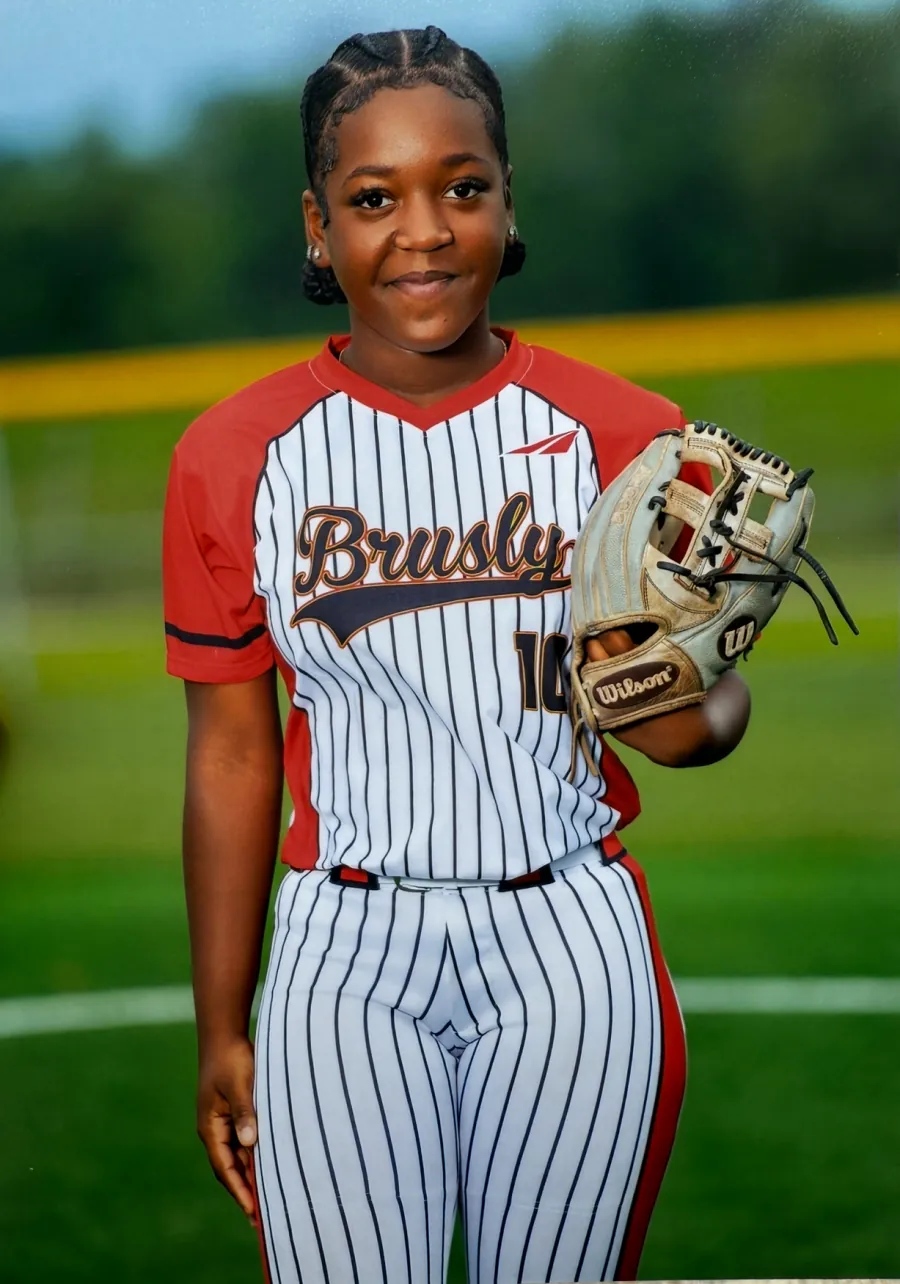 Kennedi Fair (#10) in her Brusly High School pinstripe uniform holding her glove