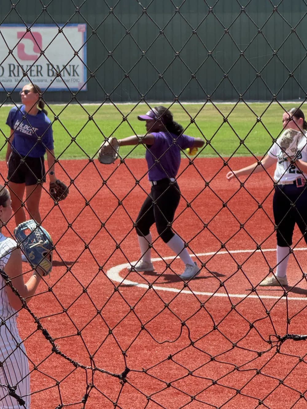 Kennedi Fair throwing in her purple XLR8 uniform during infield warmups