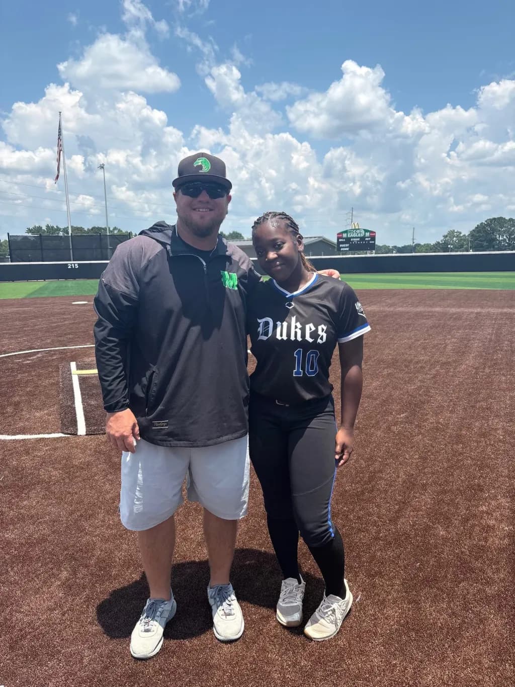 Kennedi Fair with a Meridian Community College softball coach at a camp.