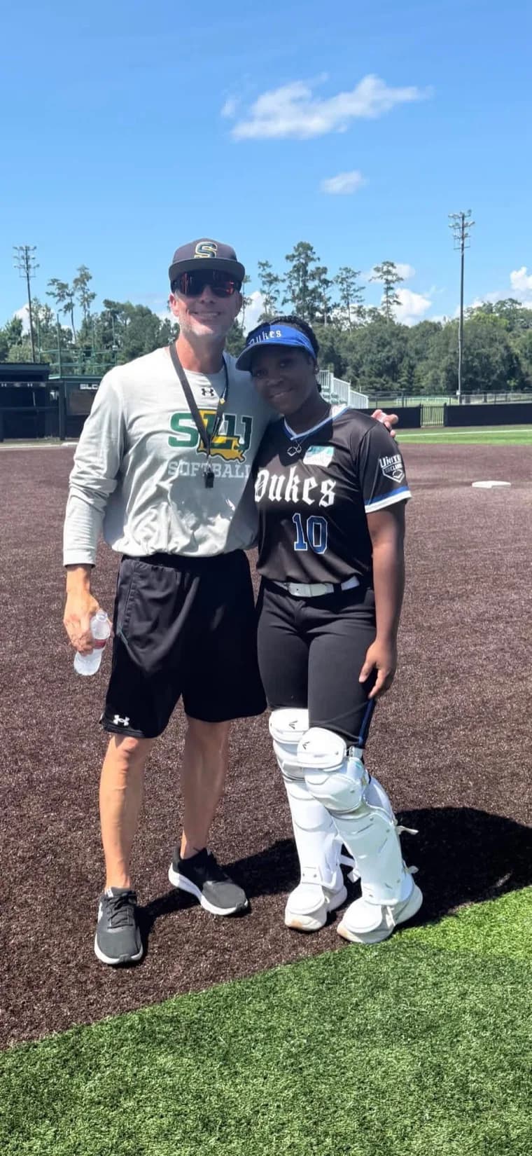 Kennedi Fair with a Southeastern Louisiana softball coach at a camp.