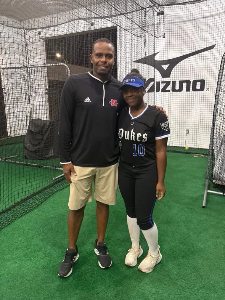 Kennedi Fair with a Nicholls State softball coach at a camp.