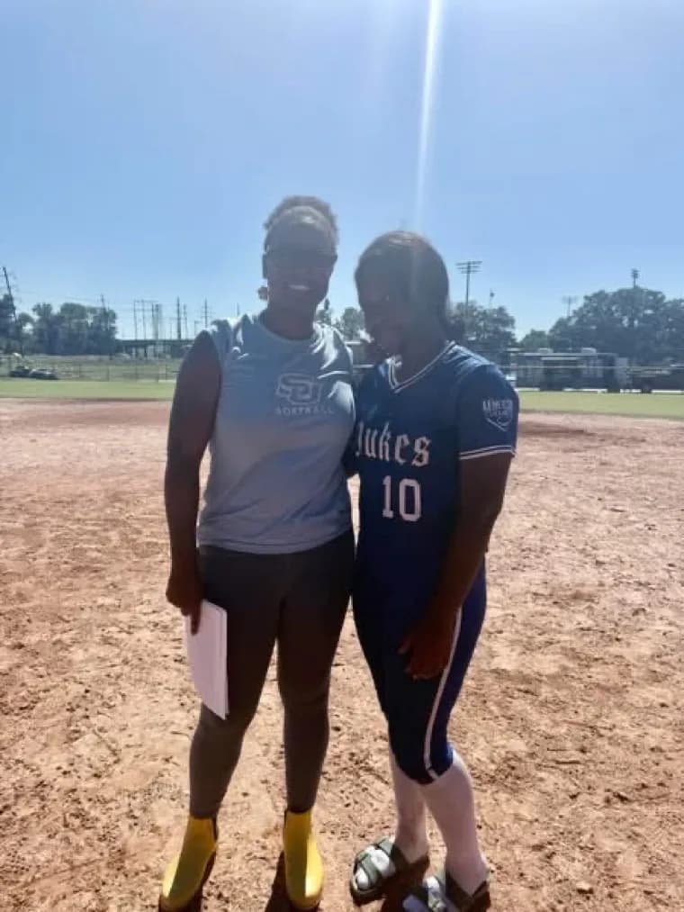 Kennedi Fair with a Southern University softball coach at a camp.