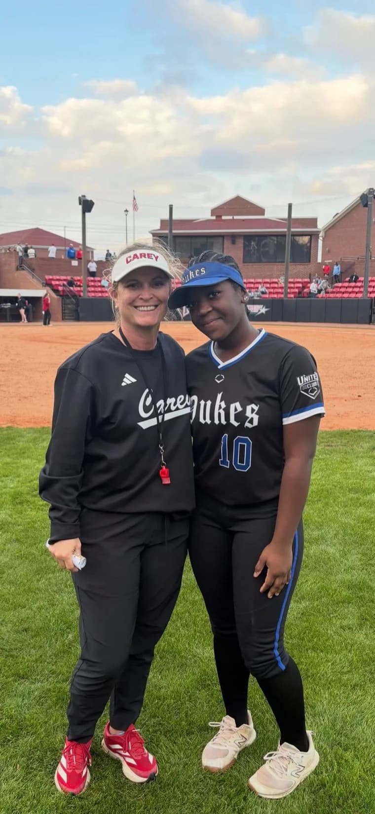 Kennedi Fair with a William Carey softball coach at a camp.