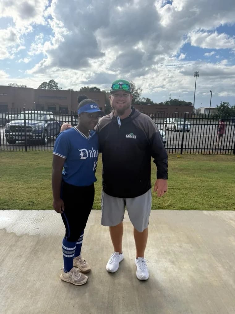 Kennedi Fair with a Meridian Community College softball coach at a camp.