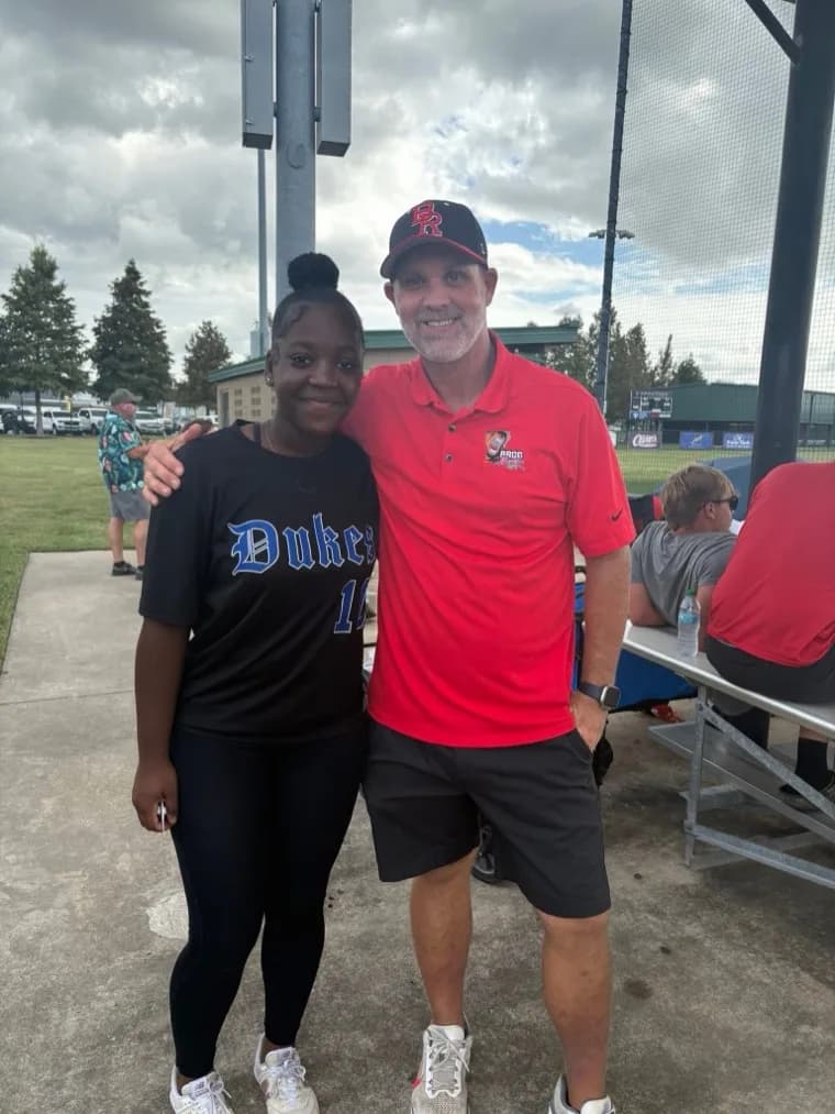 Kennedi Fair with a Baton Rouge CC softball coach at a camp.