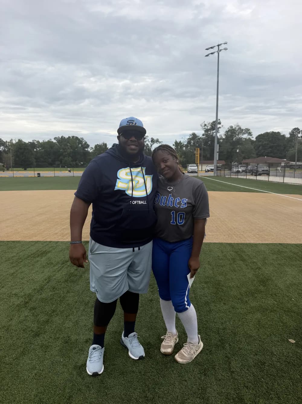 Kennedi Fair with a Southern University softball coach at a camp.