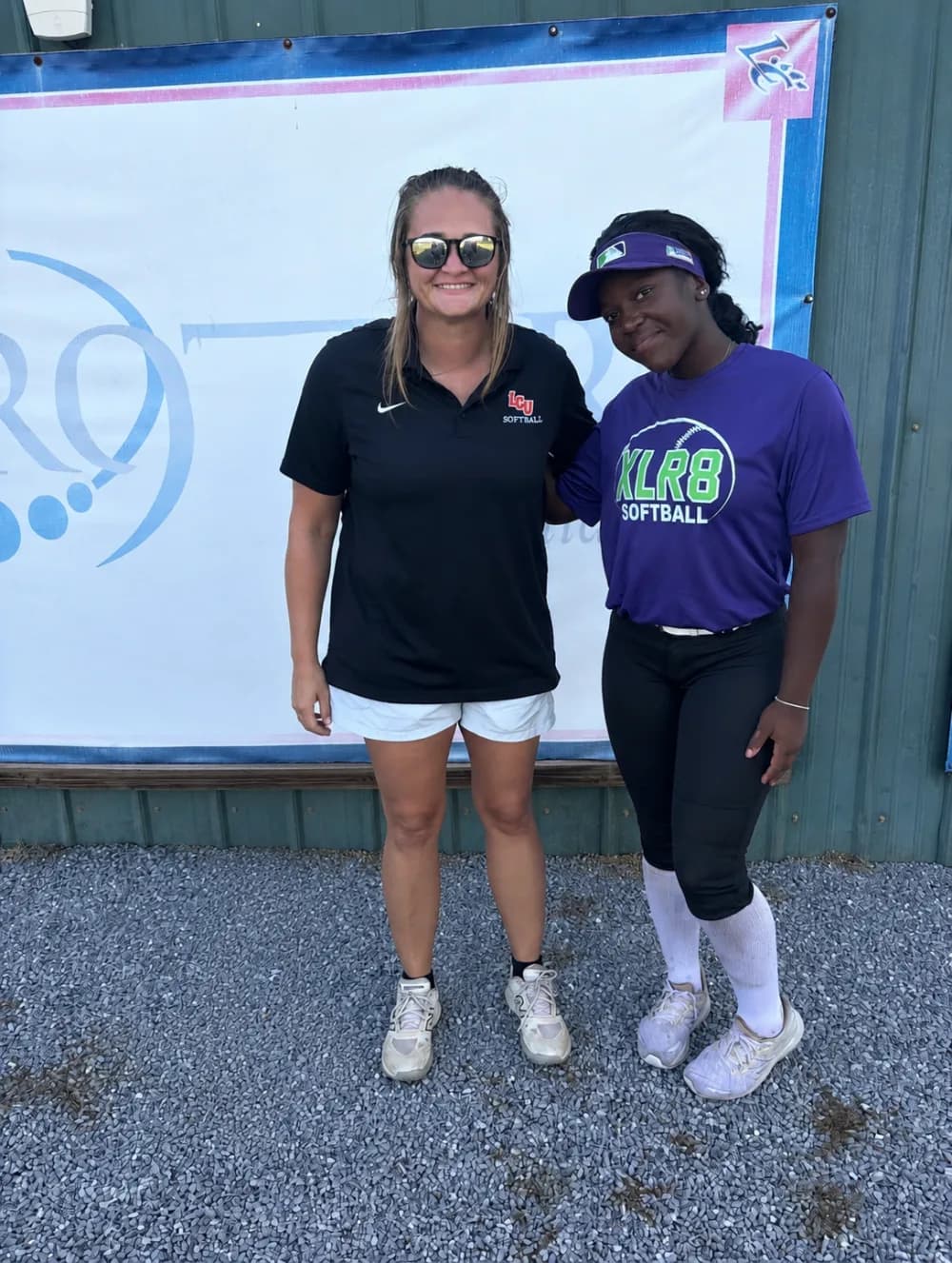 Kennedi Fair with a Louisiana Christian softball coach at a camp.