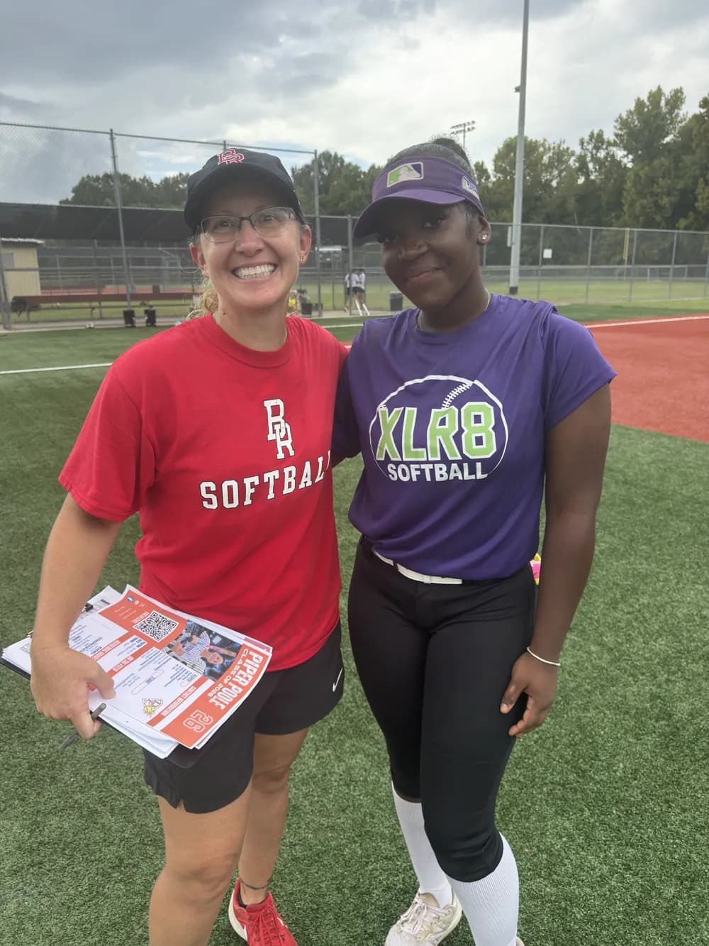 Kennedi Fair with a Baton Rouge CC softball coach at a camp.