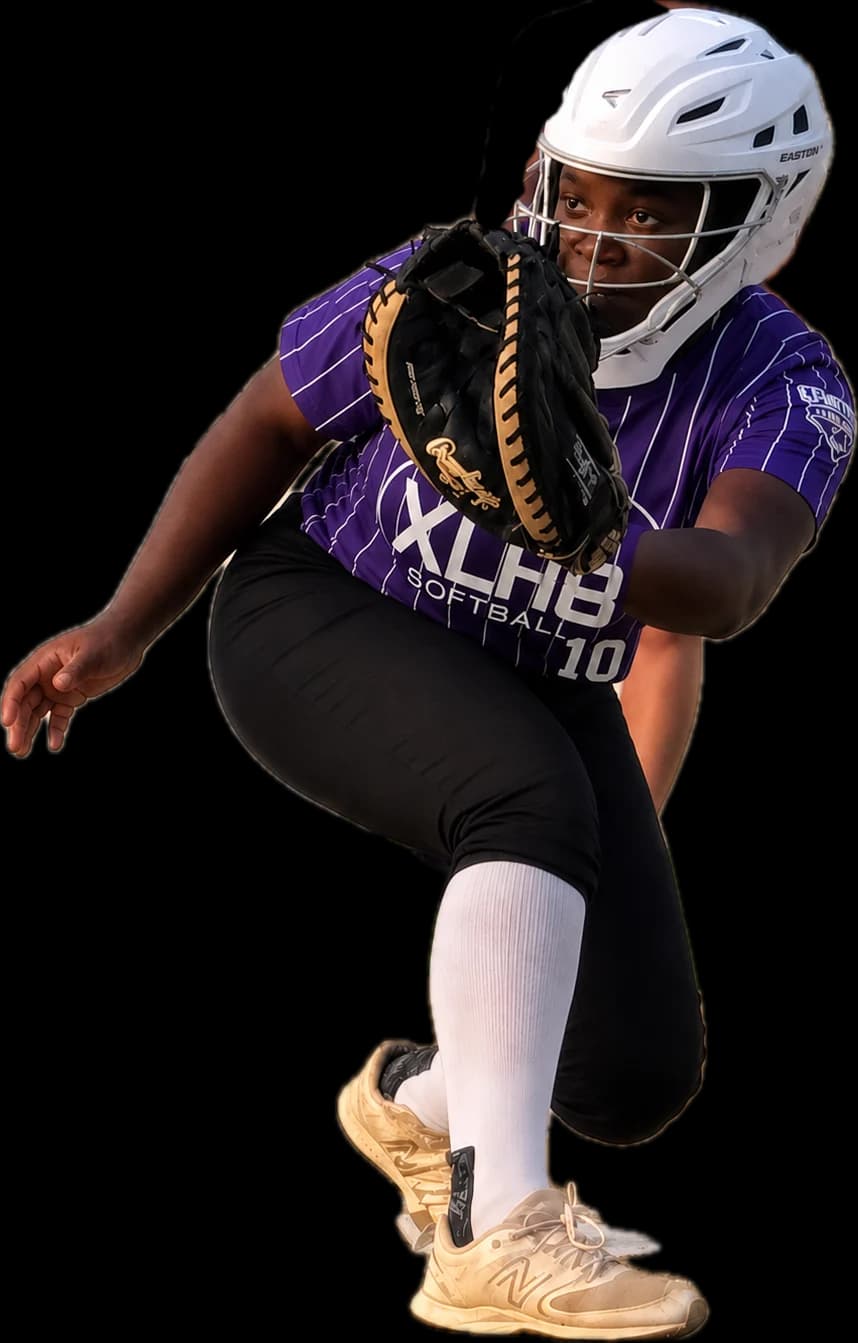 Kennedi Fair, Class of 2028 softball catcher, fielding in front of the plate in her XLR8 uniform and catcher's helmet.