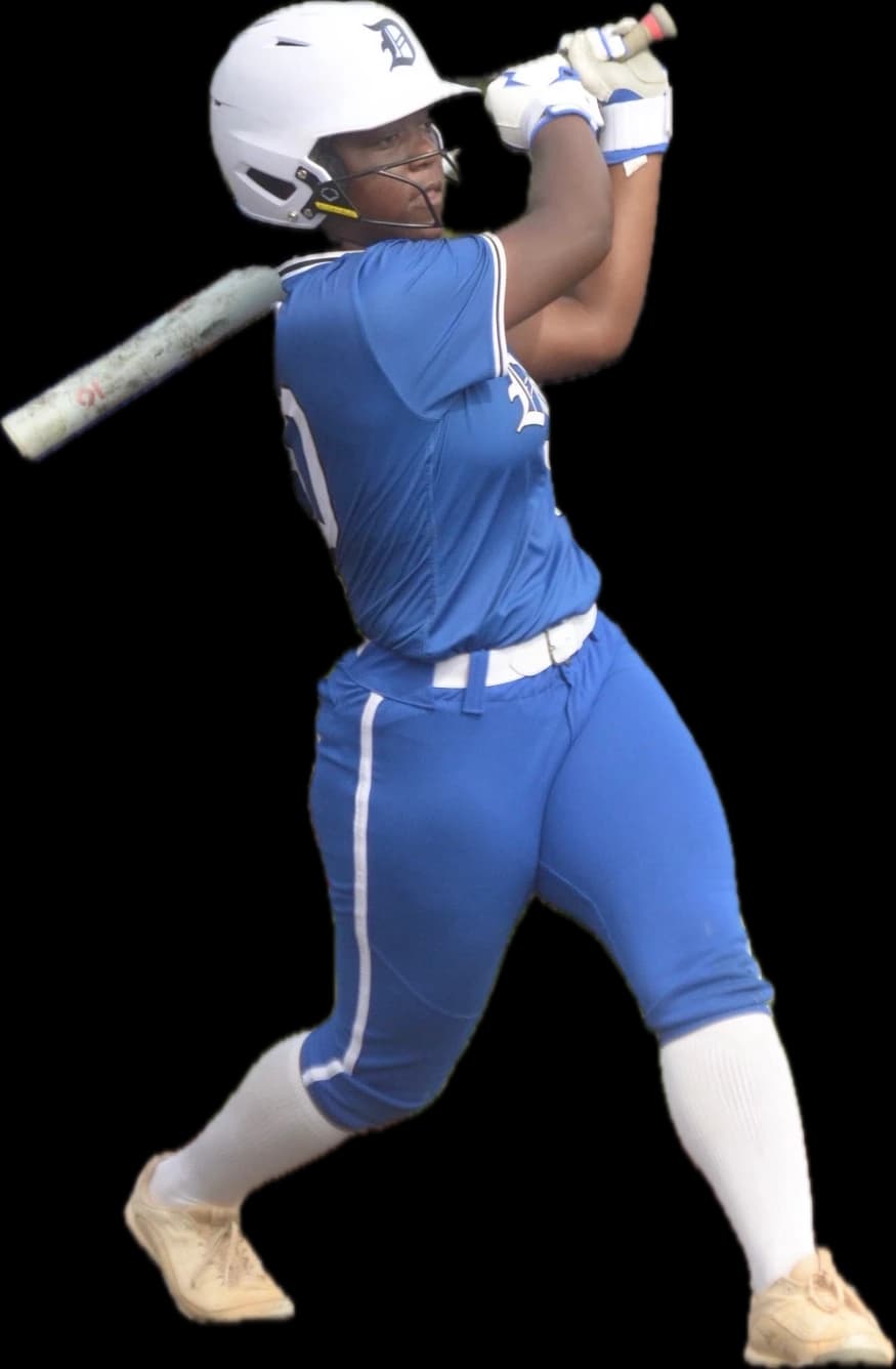 Kennedi Fair, Class of 2028 softball catcher, mid-swing in her Dukes uniform.